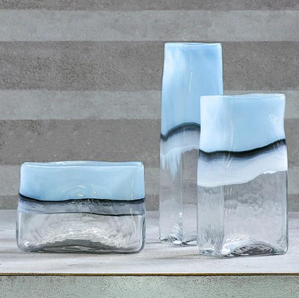 a couple of glass vases sitting on top of a table