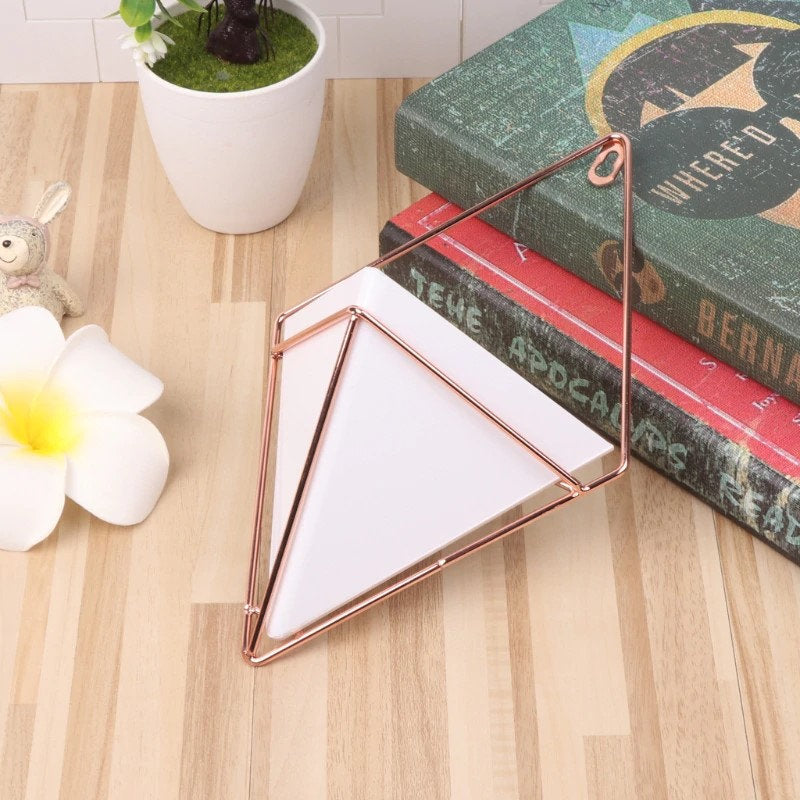 a triangle shaped object sitting on top of a wooden table