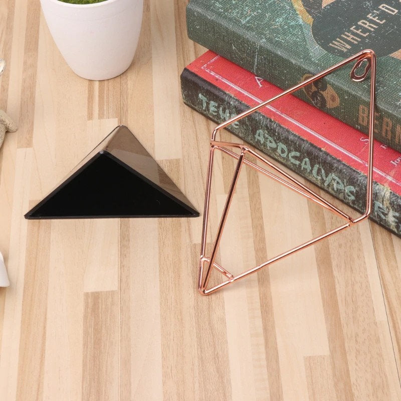 a triangle shaped object sitting on top of a wooden floor