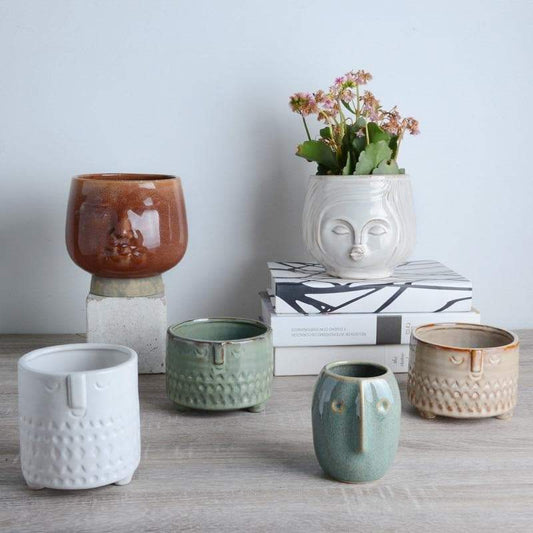 a group of ceramic cups sitting on top of a table