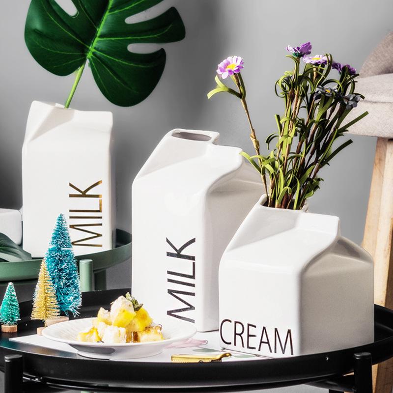 a table topped with vases and a plate of food