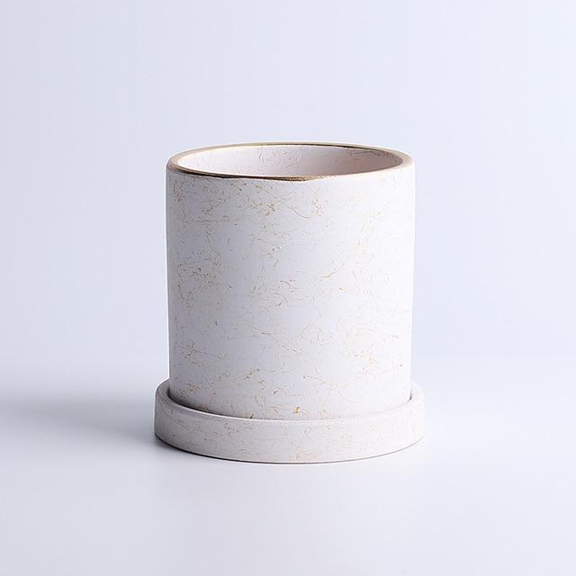 a white vase sitting on top of a white table