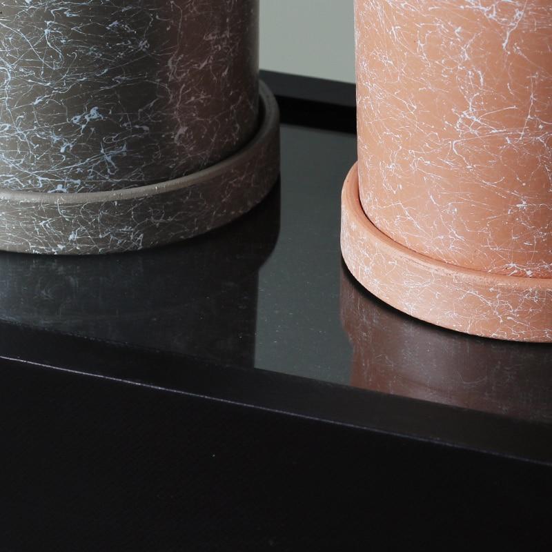 a close up of two vases on a table