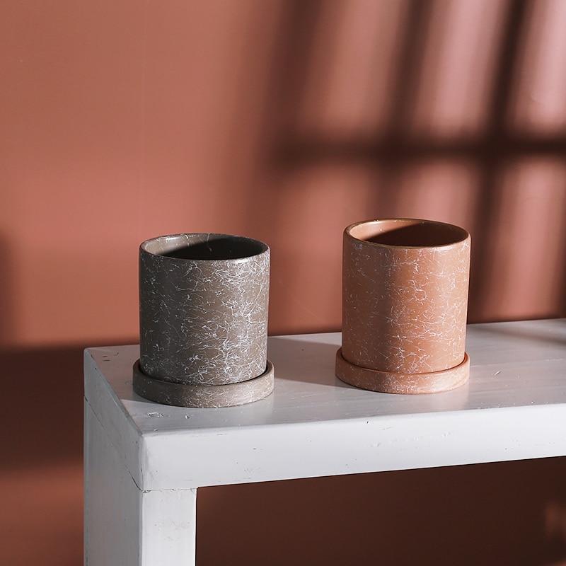 a couple of vases sitting on top of a white table