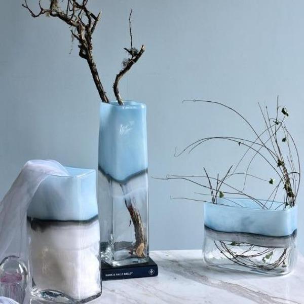 a couple of vases sitting on top of a table