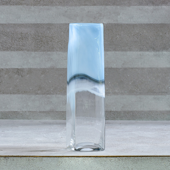 a glass vase sitting on top of a table